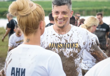 Man and a woman talking smiling in the mud