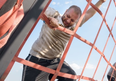 man climbing an obstacle