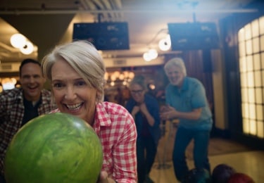 Mature friends bowling