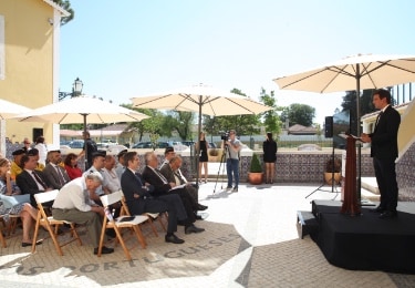 man giving a speech in front of a group of people